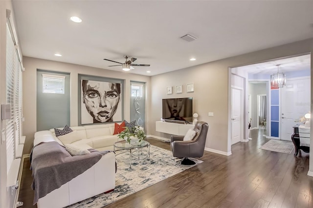 living room featuring visible vents, baseboards, dark wood-style floors, recessed lighting, and ceiling fan with notable chandelier