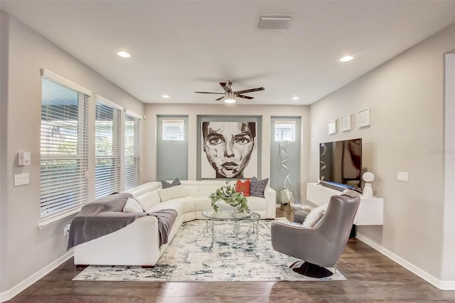 living area with a ceiling fan, visible vents, recessed lighting, wood finished floors, and baseboards