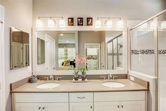 full bath with a sink, double vanity, and a stall shower