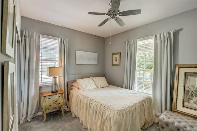 bedroom featuring ceiling fan and light carpet