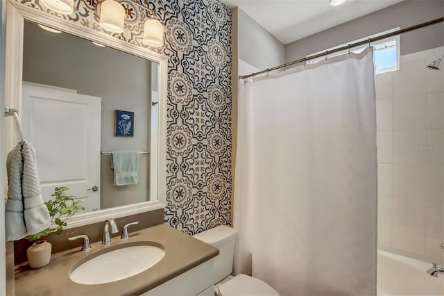 bathroom featuring toilet, vanity, and shower / bath combination with curtain