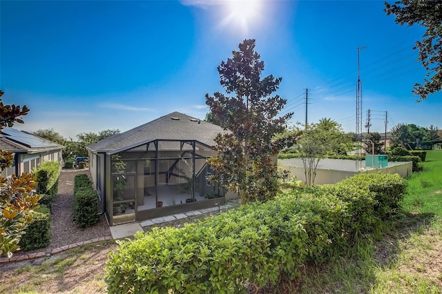 back of property with a lanai