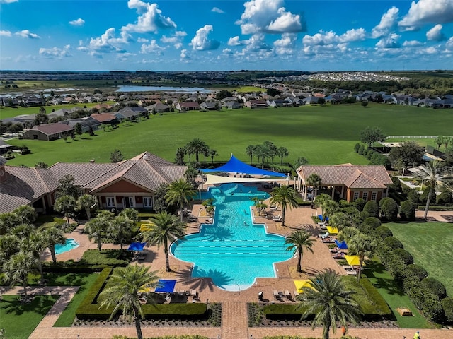 community pool with a residential view and a patio
