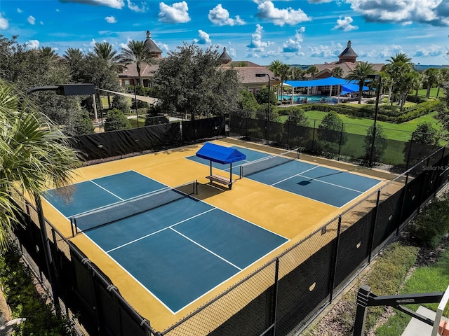 view of tennis court with fence