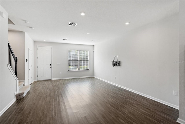 6165 Juneberry Way, Winter Garden, FL 34787 - unfurnished living room featuring stairs, dark wood-style flooring, baseboards, and visible vents