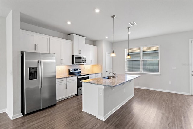 6165 Juneberry Way, Winter Garden, FL 34787 - kitchen with appliances with stainless steel finishes, dark wood-style flooring, backsplash, and white cabinets