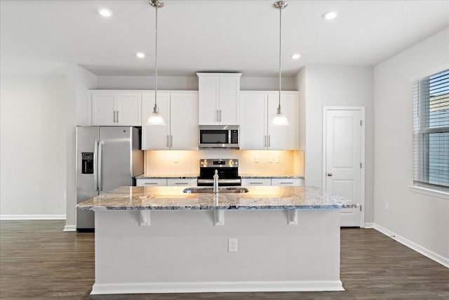 6165 Juneberry Way, Winter Garden, FL 34787 - kitchen with stainless steel appliances, white cabinets, baseboards, and decorative backsplash