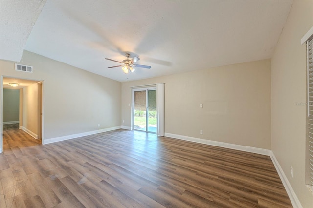 unfurnished room with wood finished floors, ceiling fan, baseboards, and visible vents