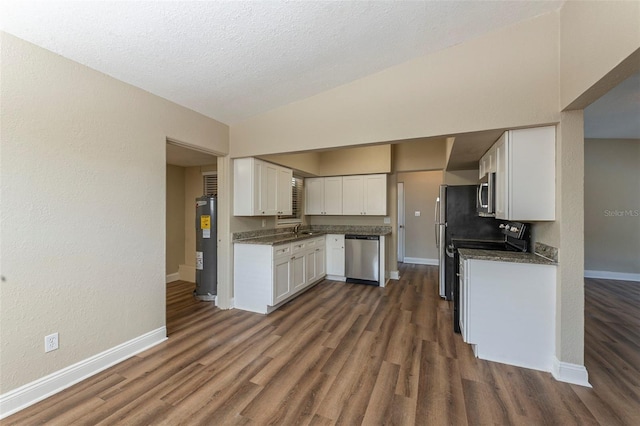 kitchen with dark wood-type flooring, appliances with stainless steel finishes, baseboards, and white cabinetry