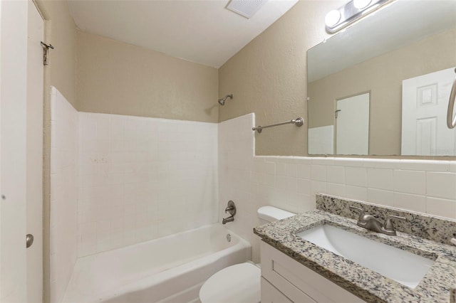 full bathroom with vanity,  shower combination, visible vents, toilet, and tile walls