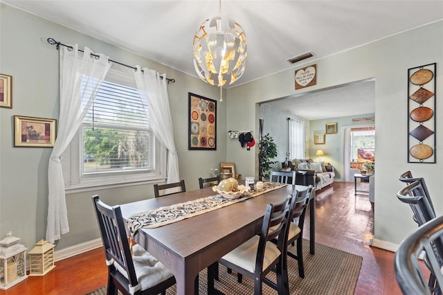 1204 N Shore Dr, Jacksonville, FL 32208 - dining area featuring visible vents, baseboards, an inviting chandelier, and wood finished floors