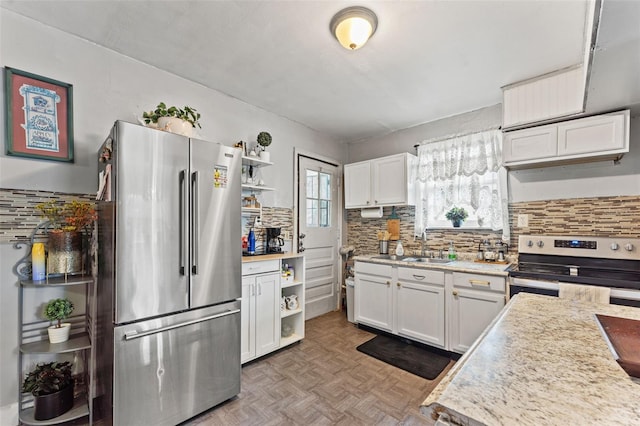 1204 N Shore Dr, Jacksonville, FL 32208 - kitchen featuring white cabinets, open shelves, a sink, appliances with stainless steel finishes, and decorative backsplash