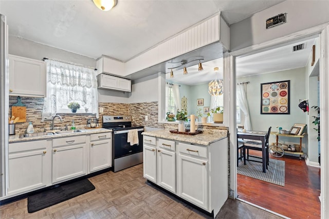 1204 N Shore Dr, Jacksonville, FL 32208 - kitchen featuring tasteful backsplash, visible vents, a sink, electric stove, and white cabinetry
