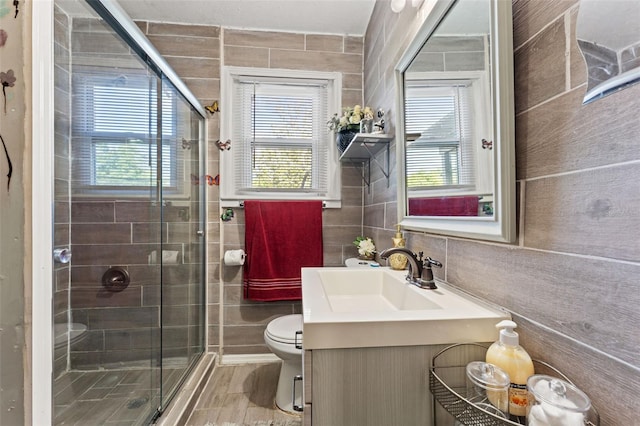 1204 N Shore Dr, Jacksonville, FL 32208 - bathroom with toilet, tile walls, a stall shower, and vanity