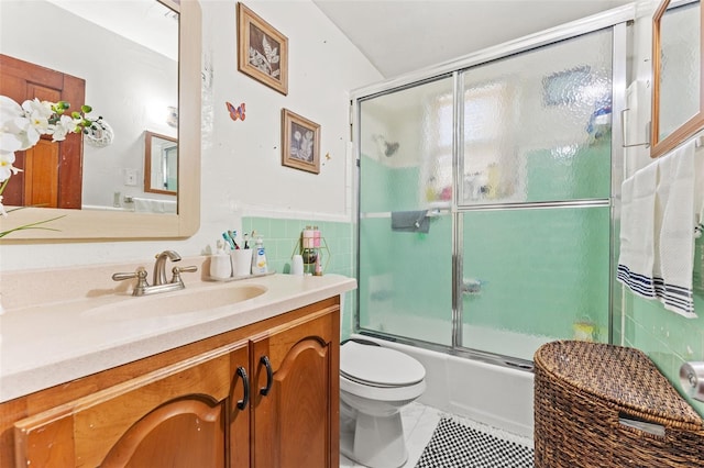 1204 N Shore Dr, Jacksonville, FL 32208 - full bath featuring tile walls, vanity, toilet, bath / shower combo with glass door, and tile patterned floors