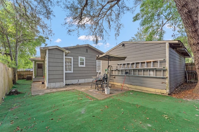 1204 N Shore Dr, Jacksonville, FL 32208 - rear view of house with a fenced backyard and a lawn
