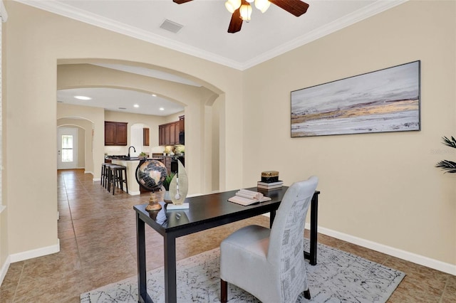 home office featuring crown molding, light tile patterned floors, arched walkways, a ceiling fan, and visible vents