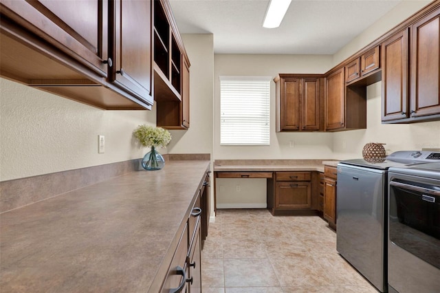 washroom featuring cabinet space and separate washer and dryer