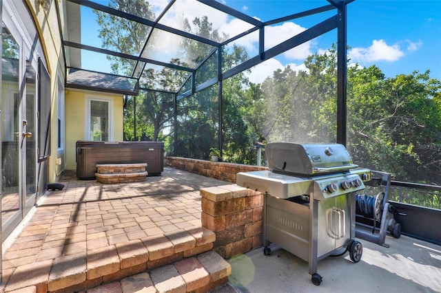 view of patio / terrace featuring a grill, a lanai, and a hot tub