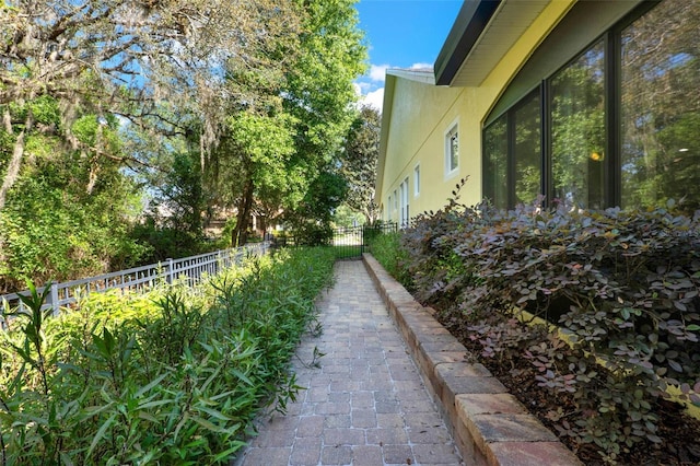 view of property exterior featuring stucco siding and fence