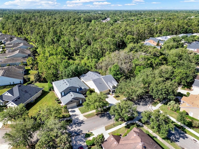 bird's eye view featuring a forest view and a residential view