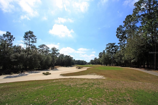 view of property's community featuring a yard and golf course view