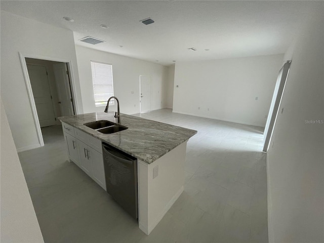 kitchen featuring visible vents, dishwashing machine, white cabinetry, and a sink