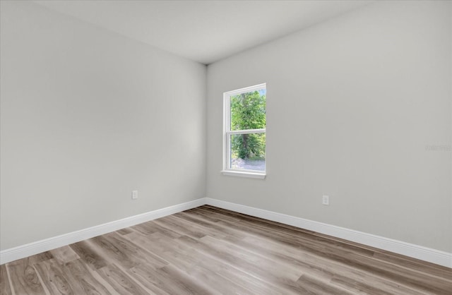 empty room featuring light wood-style flooring and baseboards