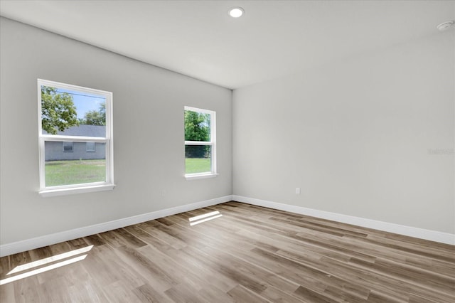 empty room with baseboards and wood finished floors