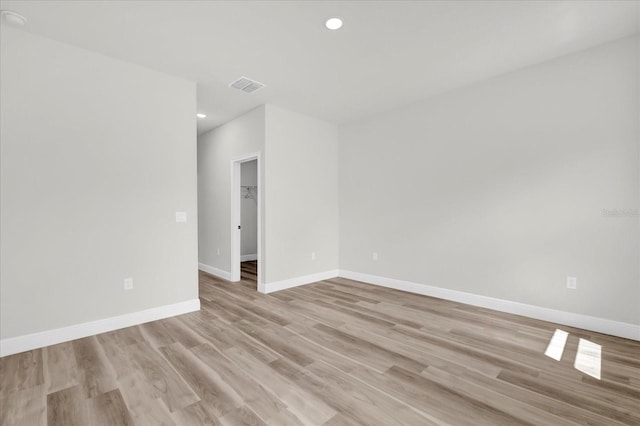 unfurnished room with visible vents, baseboards, recessed lighting, and light wood-style floors