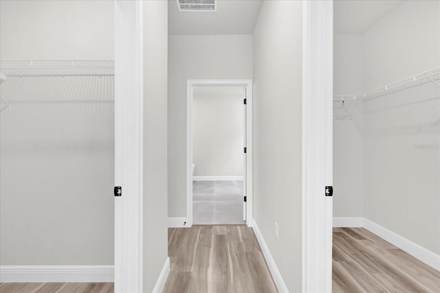 walk in closet featuring light wood-style flooring and visible vents