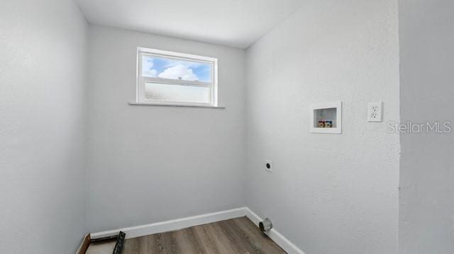 laundry room featuring baseboards, hookup for a washing machine, wood finished floors, electric dryer hookup, and laundry area