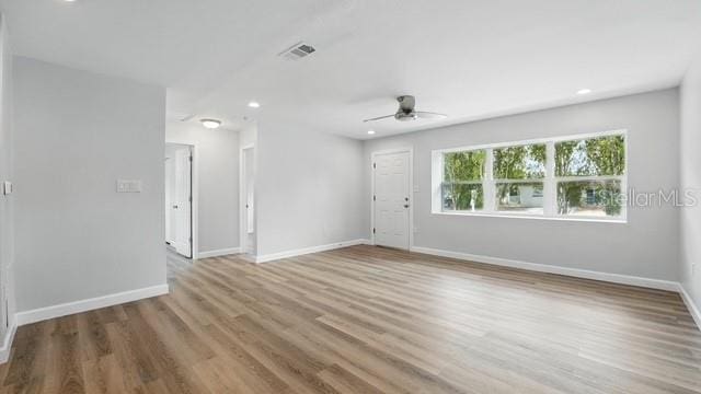 spare room with recessed lighting, wood finished floors, visible vents, baseboards, and ceiling fan