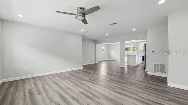 spare room featuring recessed lighting, wood finished floors, visible vents, and baseboards