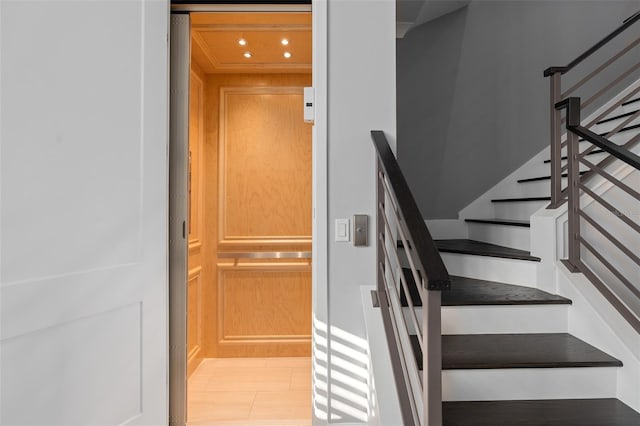 staircase featuring recessed lighting and elevator