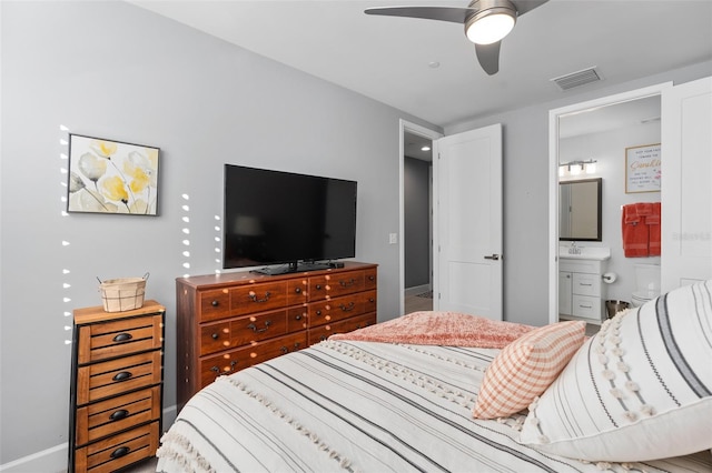 bedroom with baseboards, ensuite bathroom, ceiling fan, and visible vents