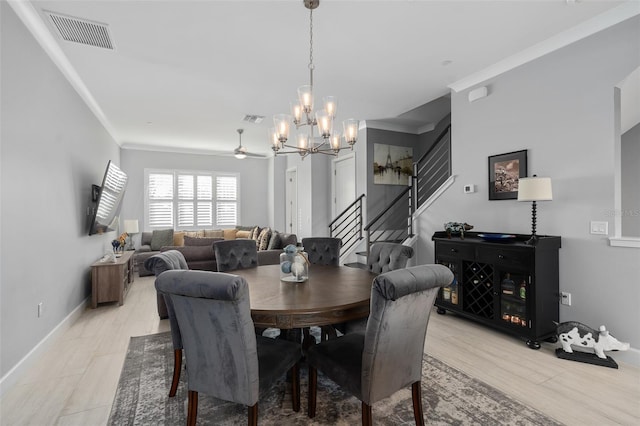 dining area featuring baseboards, a chandelier, crown molding, stairs, and visible vents