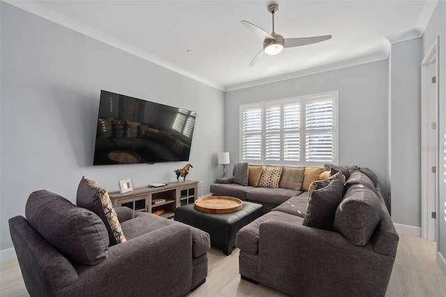 living area featuring crown molding, ceiling fan, and baseboards