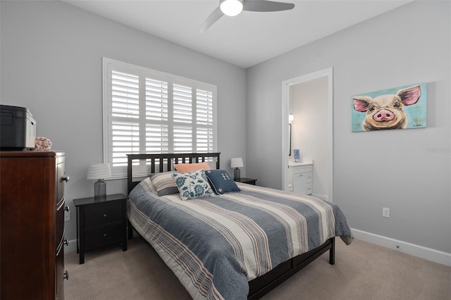 bedroom featuring a ceiling fan, light colored carpet, baseboards, and connected bathroom