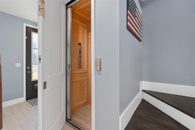 hallway featuring baseboards