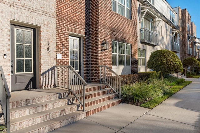 entrance to property featuring brick siding