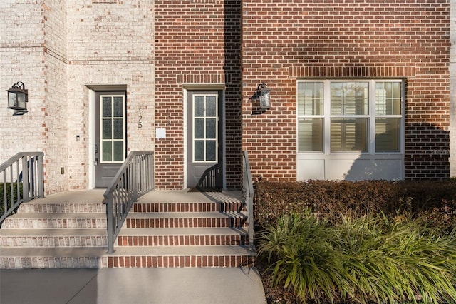 view of exterior entry with brick siding