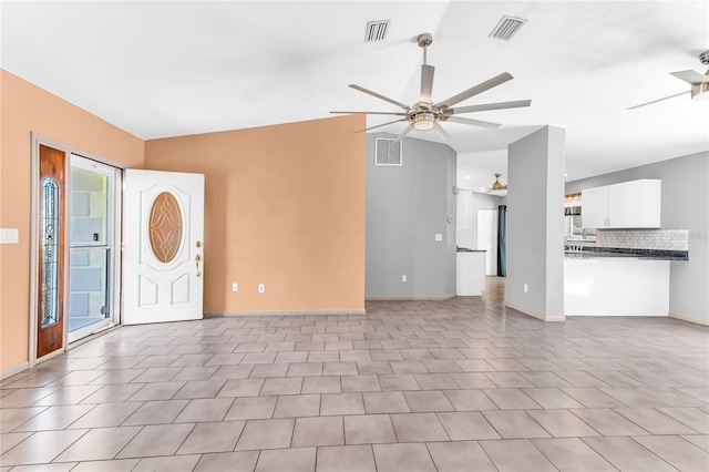 58 Barkwood Ln, Palm Coast, FL 32137 - unfurnished living room with visible vents, baseboards, and ceiling fan
