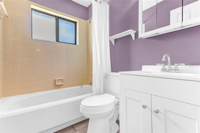 58 Barkwood Ln, Palm Coast, FL 32137 - full bathroom featuring tile patterned floors, shower / bathtub combination with curtain, vanity, and toilet