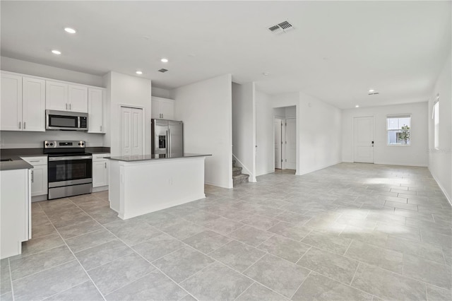 kitchen with visible vents, white cabinets, dark countertops, recessed lighting, and stainless steel appliances