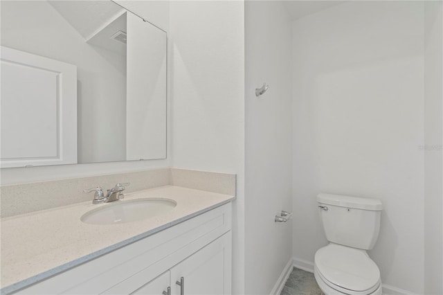 bathroom featuring toilet, vanity, baseboards, and visible vents
