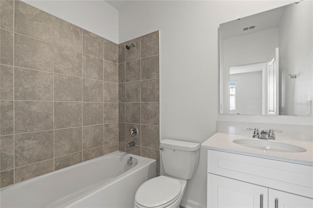 bathroom with visible vents, toilet, vanity, and bathing tub / shower combination