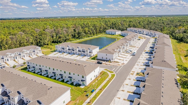 birds eye view of property featuring a view of trees and a water view
