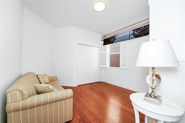 living area featuring wood finished floors and baseboards