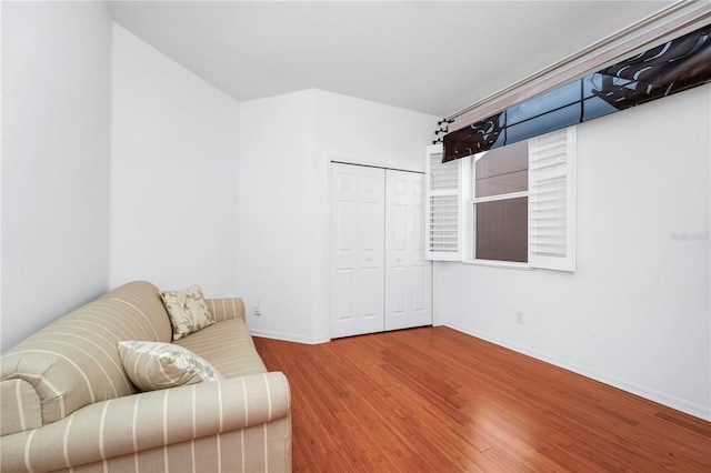 sitting room featuring baseboards and wood finished floors